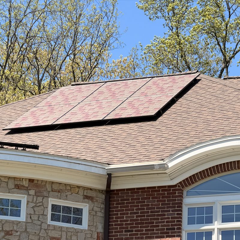 Brick house with black solar panels across the front roof